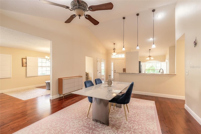 dining area featuring plenty of natural light, ceiling fan, vaulted ceiling, and hardwood / wood-style floors