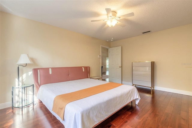 bedroom with ceiling fan and dark hardwood / wood-style flooring