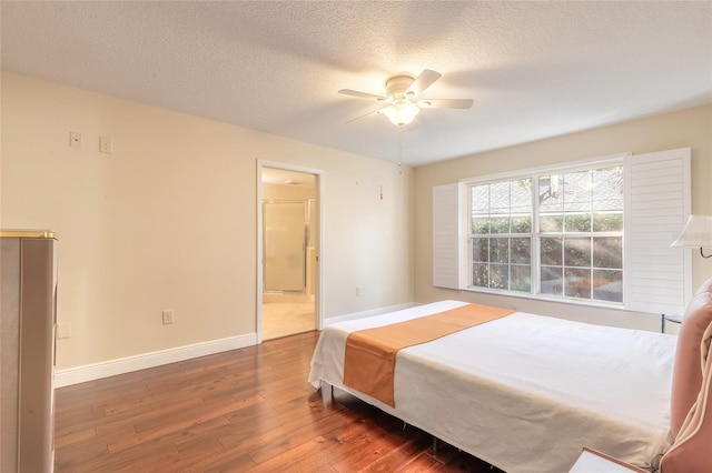 bedroom featuring ceiling fan, dark hardwood / wood-style flooring, and a textured ceiling