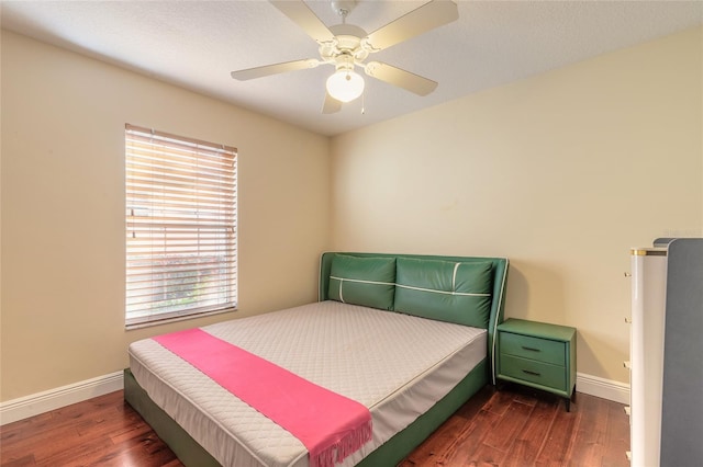 bedroom featuring dark hardwood / wood-style flooring and ceiling fan