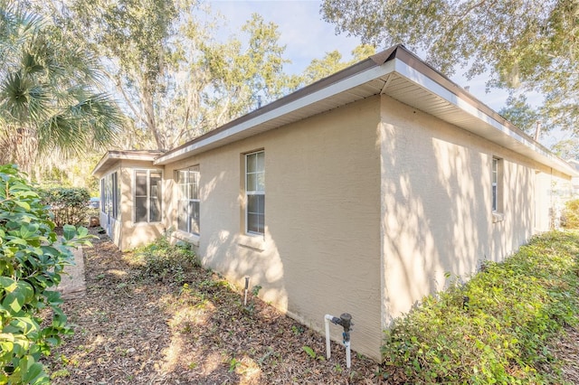 view of side of property with a sunroom