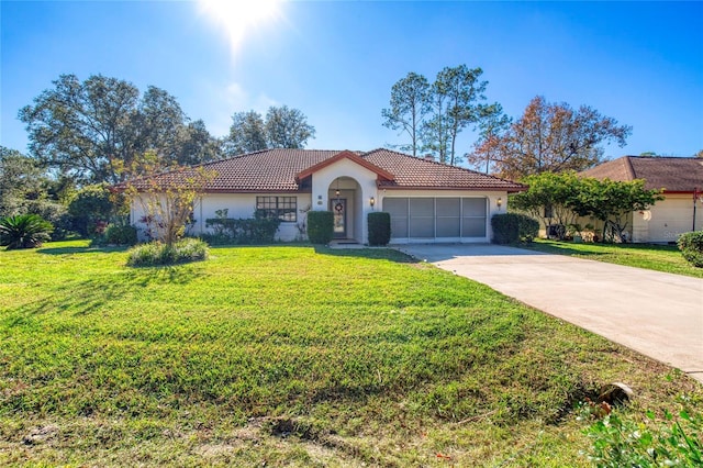 view of front of home featuring a garage and a front lawn