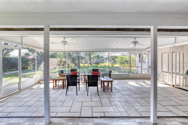 unfurnished sunroom with ceiling fan and a wealth of natural light