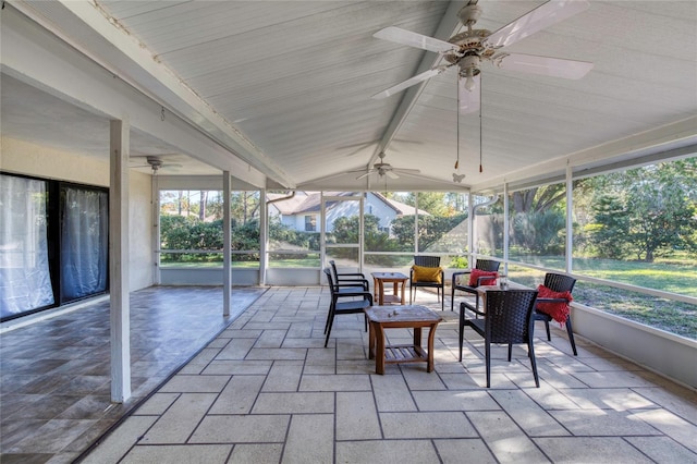 sunroom featuring vaulted ceiling