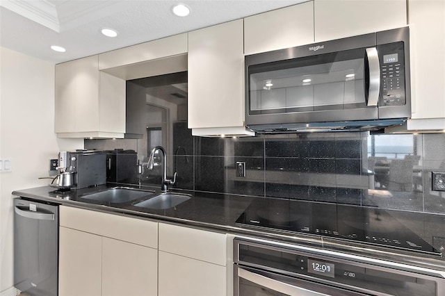 kitchen with decorative backsplash, crown molding, sink, and appliances with stainless steel finishes