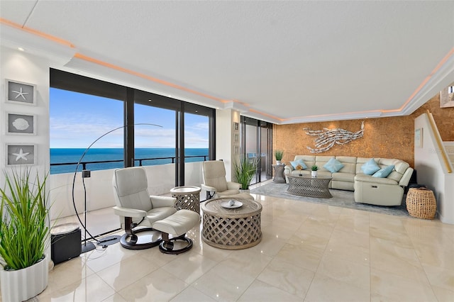 living room featuring light tile patterned floors, a water view, a wall of windows, and ornamental molding