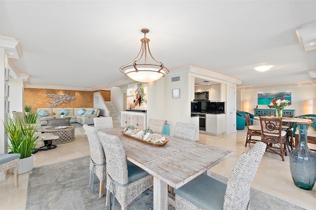 tiled dining space featuring crown molding