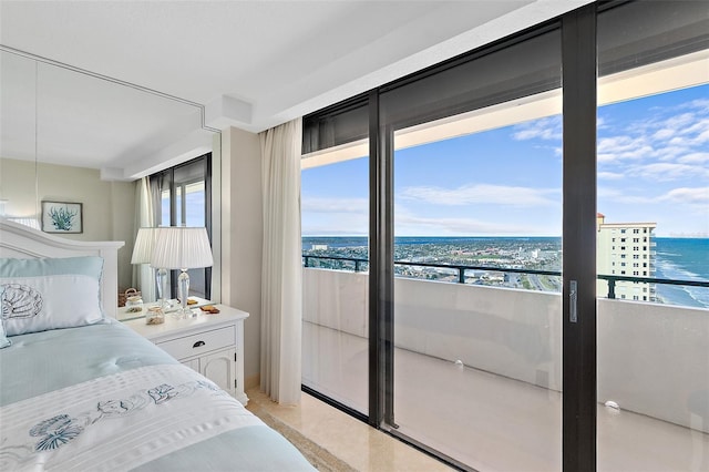 bedroom with a water view and a view of the beach