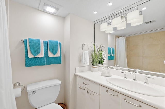 bathroom with vanity, toilet, and curtained shower