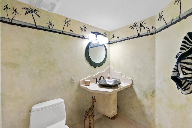 bathroom with tile patterned floors, sink, and toilet