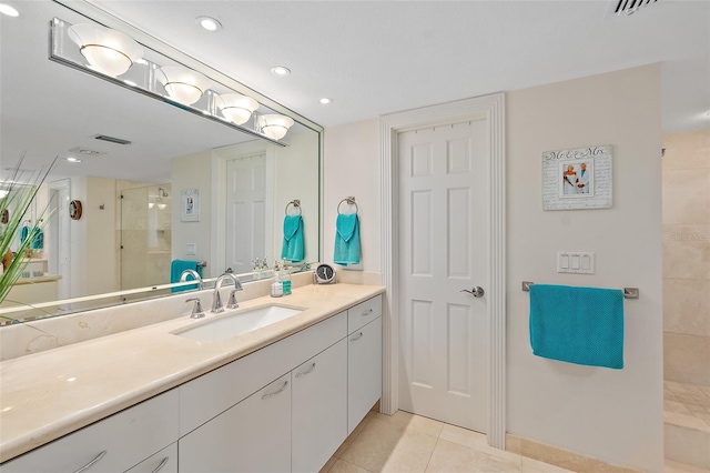 bathroom with tile patterned floors, vanity, and walk in shower