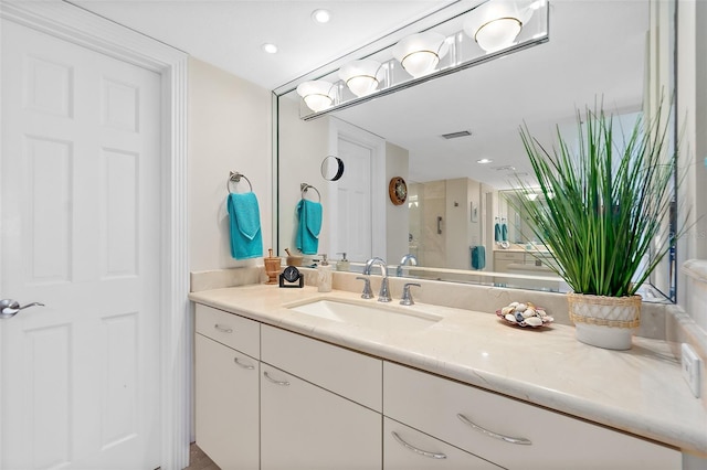 bathroom featuring vanity and a shower