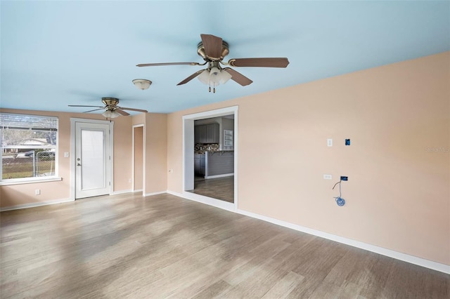 empty room featuring ceiling fan and light hardwood / wood-style flooring