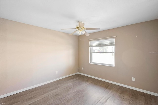 empty room featuring wood-type flooring and ceiling fan