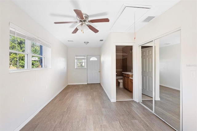 entryway featuring ceiling fan, a healthy amount of sunlight, and light hardwood / wood-style flooring