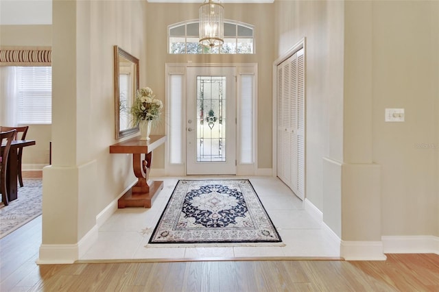 foyer with hardwood / wood-style flooring and a notable chandelier