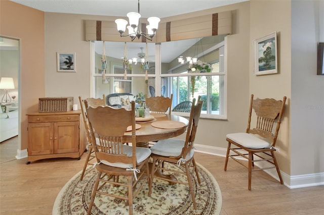 dining room with a notable chandelier and light hardwood / wood-style floors