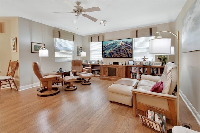 living room featuring ceiling fan and light hardwood / wood-style flooring