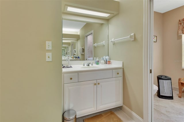 bathroom featuring tile patterned floors, vanity, and toilet