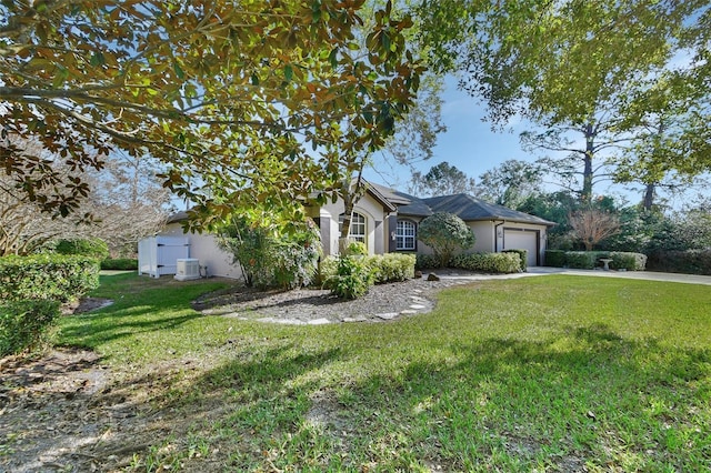 view of front of property with a garage and a front lawn