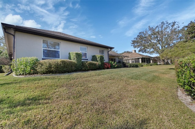 view of side of home with a lawn