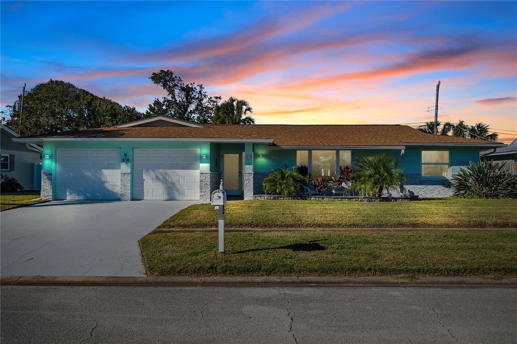 ranch-style house with a lawn and a garage