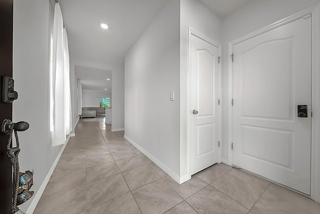 hall featuring light tile patterned flooring