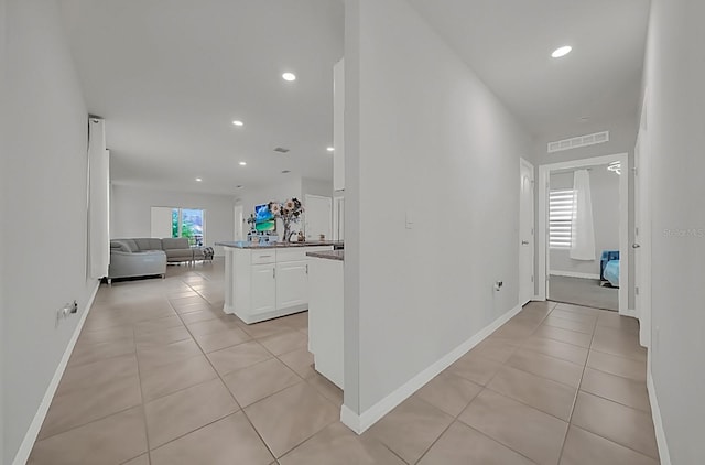 hall featuring light tile patterned flooring