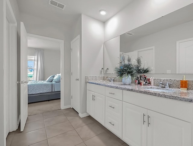 bathroom with tile patterned flooring and vanity