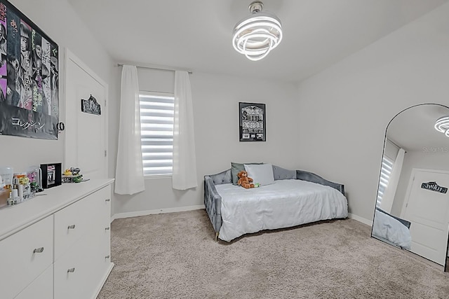 bedroom featuring light colored carpet and multiple windows