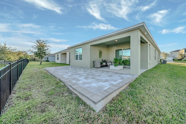 back of property featuring a yard, a patio, and central AC