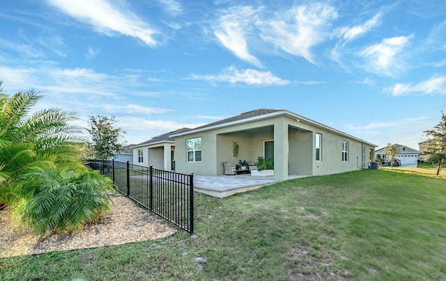 back of house featuring a yard and a patio