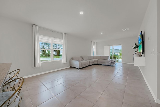 unfurnished living room with light tile patterned flooring