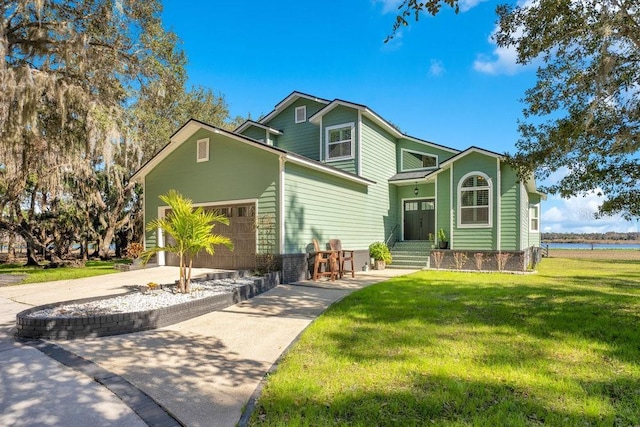 view of front property with a garage, a water view, and a front lawn