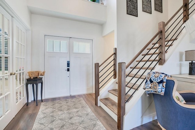 entryway featuring french doors, a wealth of natural light, and hardwood / wood-style floors