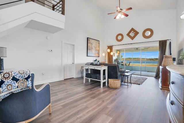 living room featuring hardwood / wood-style flooring, high vaulted ceiling, and ceiling fan