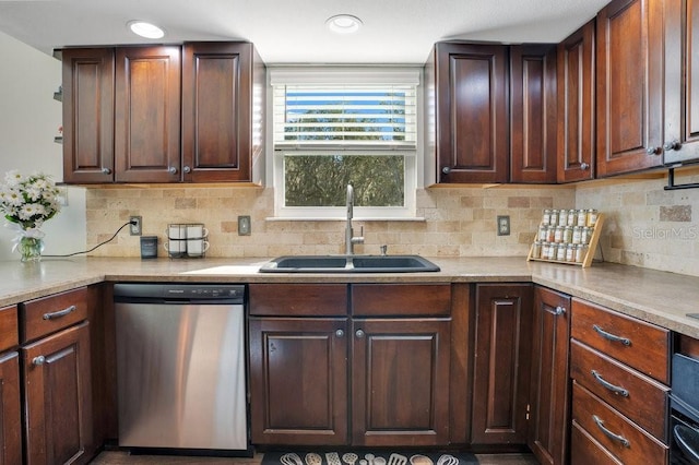 kitchen featuring backsplash, dishwasher, dark brown cabinetry, and sink