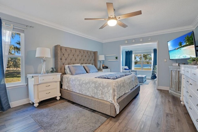 bedroom with ceiling fan, wood-type flooring, and ornamental molding