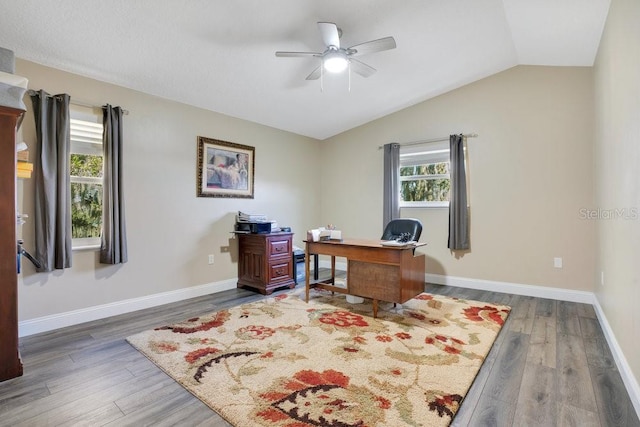 office area featuring dark hardwood / wood-style flooring, ceiling fan, and lofted ceiling