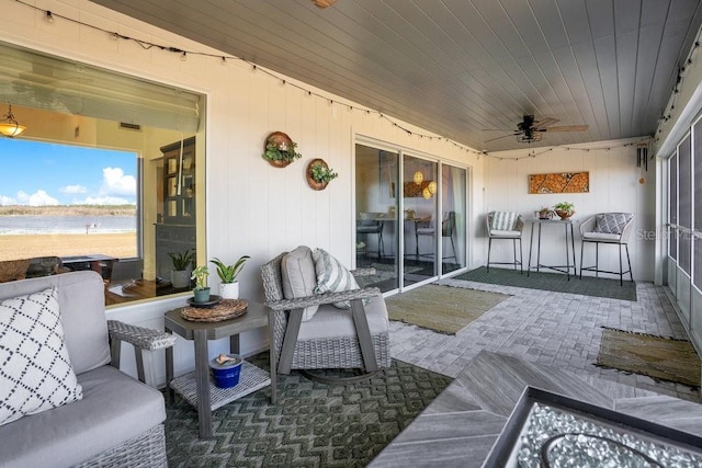 view of patio / terrace with a water view and ceiling fan