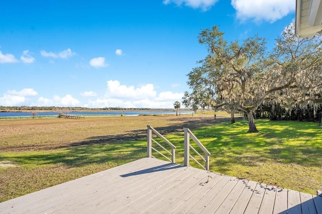 deck with a lawn and a water view