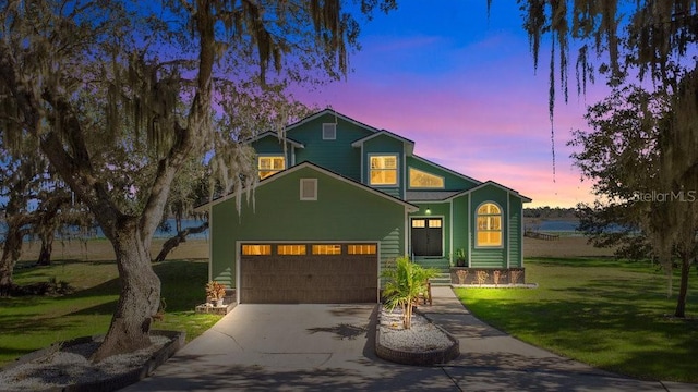 view of front of house with a yard and a garage