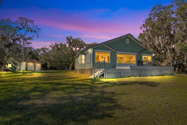 property exterior at dusk with a yard