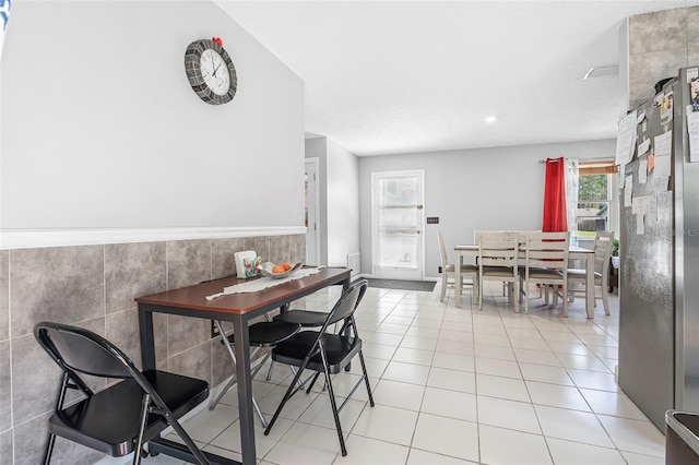 dining area featuring light tile patterned flooring