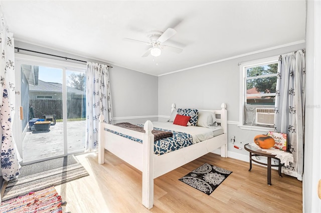 bedroom featuring access to exterior, cooling unit, ceiling fan, crown molding, and wood-type flooring