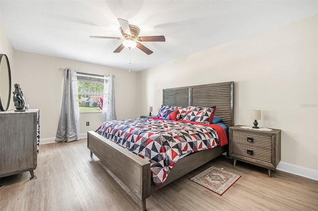 bedroom with ceiling fan and light hardwood / wood-style floors