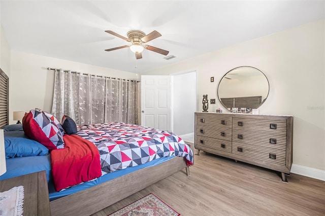 bedroom with light hardwood / wood-style floors and ceiling fan