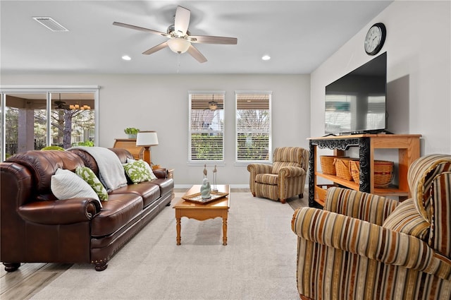 living room with ceiling fan and light hardwood / wood-style floors