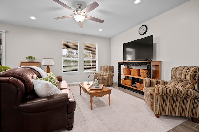 living room featuring ceiling fan and light hardwood / wood-style floors