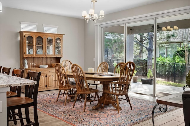 dining area featuring a chandelier and light wood-type flooring